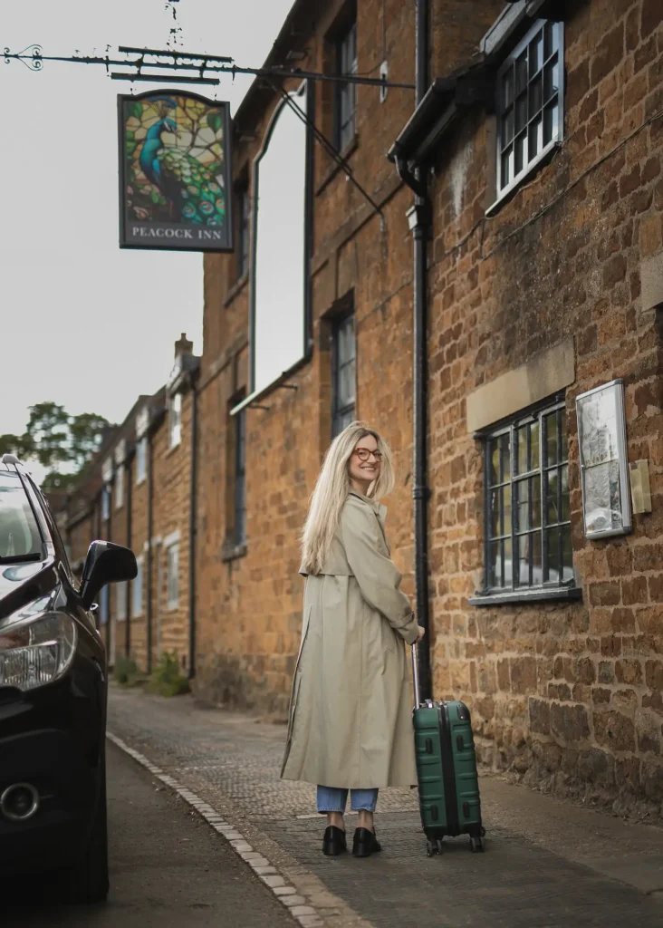 Woman with a Suitcase Standing in the Street
